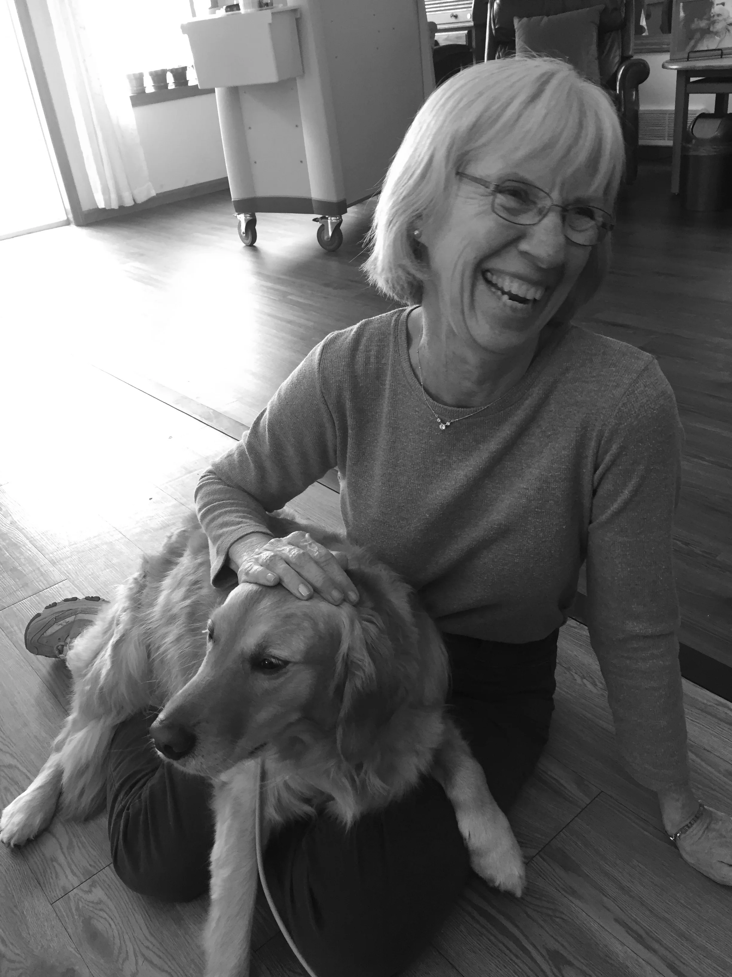 Resident laughing with the family dog