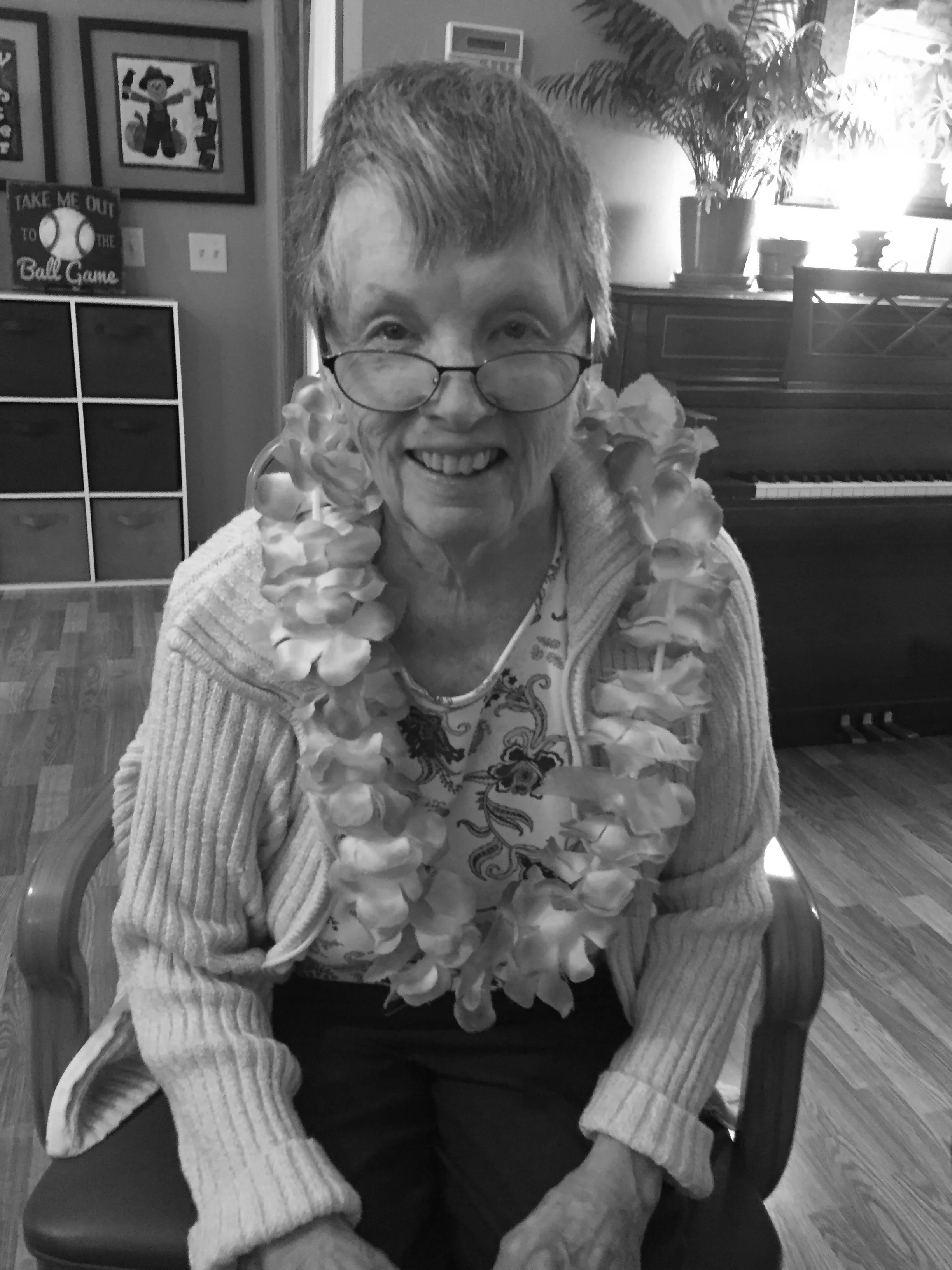 Resident celebrating with a lei